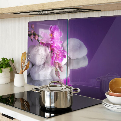 Deska kuchenna szklana z motywem kwiatów orchidei na tle kamieni