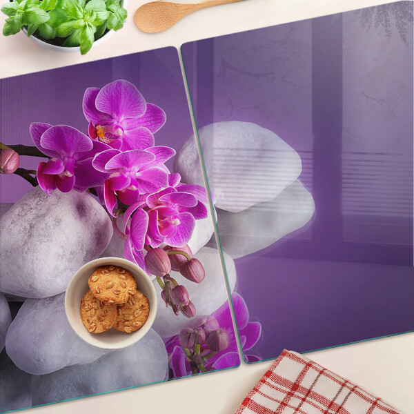 Deska kuchenna szklana z motywem kwiatów orchidei na tle kamieni