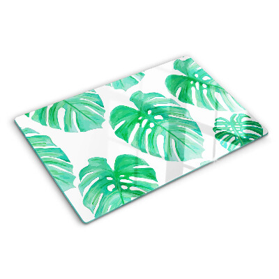 Szklana deska do krojenia z motywem liści monstery na białym tle