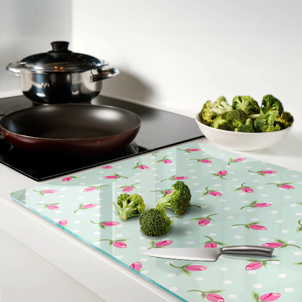 Szklana deska kuchenna z różowymi tulipanami na zielonym tle