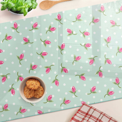 Szklana deska kuchenna z różowymi tulipanami na zielonym tle