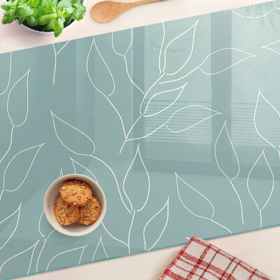 Szklana deska kuchenna z motywem liści na tle