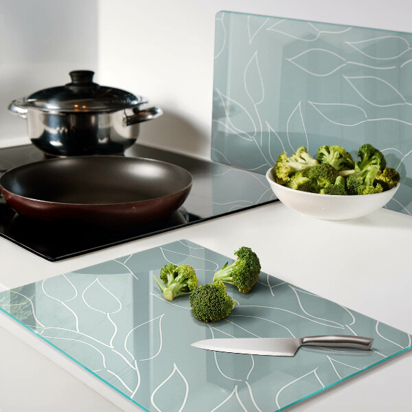 Szklana deska kuchenna z motywem liści na tle