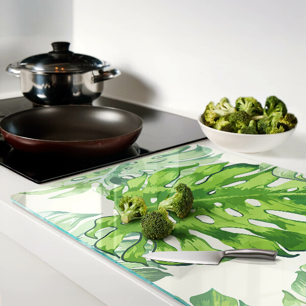 Deska kuchenna szklana z motywem liści monstery na jasnym tle