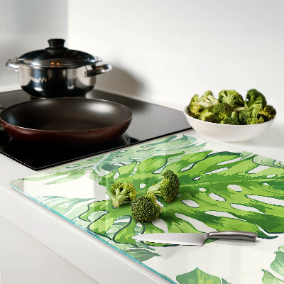 Deska kuchenna szklana z motywem liści monstery na jasnym tle