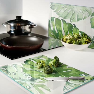 Deska kuchenna szklana z motywem liści monstery na jasnym tle