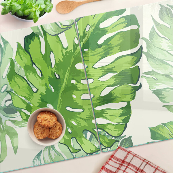 Deska kuchenna szklana z motywem liści monstery na jasnym tle