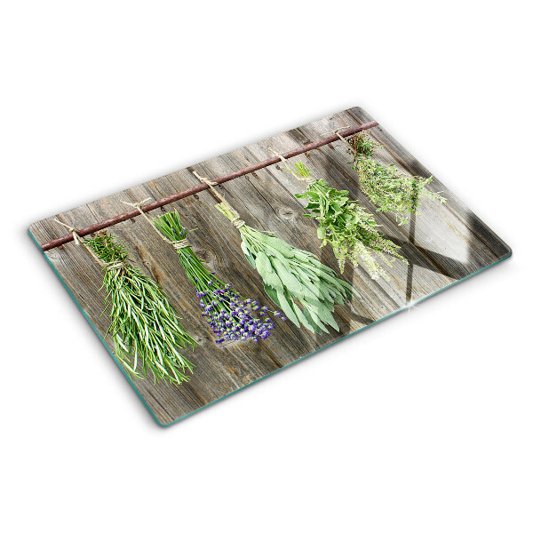 Szklana deska kuchenna z motywem ziół na tle drewnianym