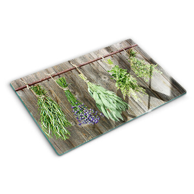 Szklana deska kuchenna z motywem ziół na tle drewnianym