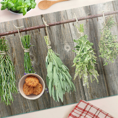 Szklana deska kuchenna z motywem ziół na tle drewnianym