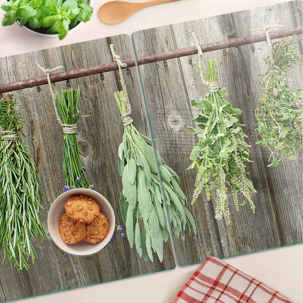 Szklana deska kuchenna z motywem ziół na tle drewnianym