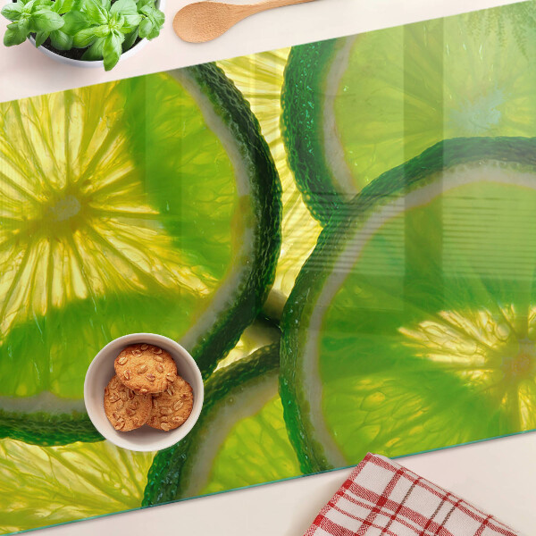 Szklana deska do krojenia z nadrukiem plasterków limonki na zielonym tle