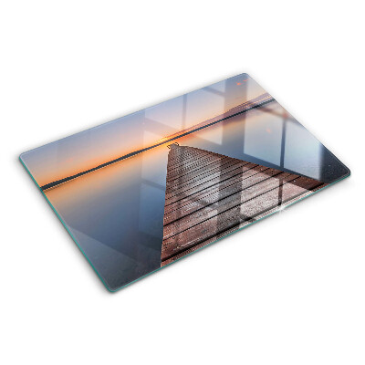 Szklana deska kuchenna z motywem molo nad jeziorem o zachodzie słońca