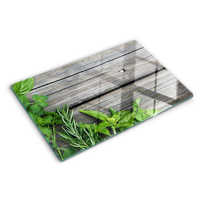 Szklana deska kuchenna z motywem zielonych ziół na drewnianym tle