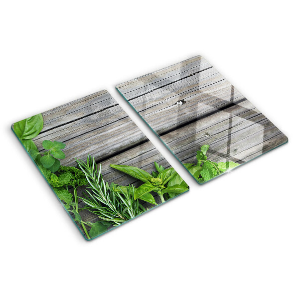 Szklana deska kuchenna z motywem zielonych ziół na drewnianym tle