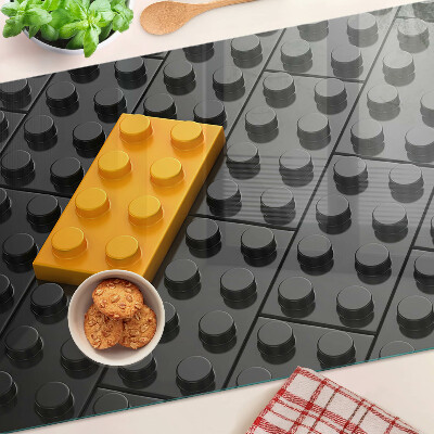 Szklana deska do krojenia z motywem klocków LEGO na czarnym tle