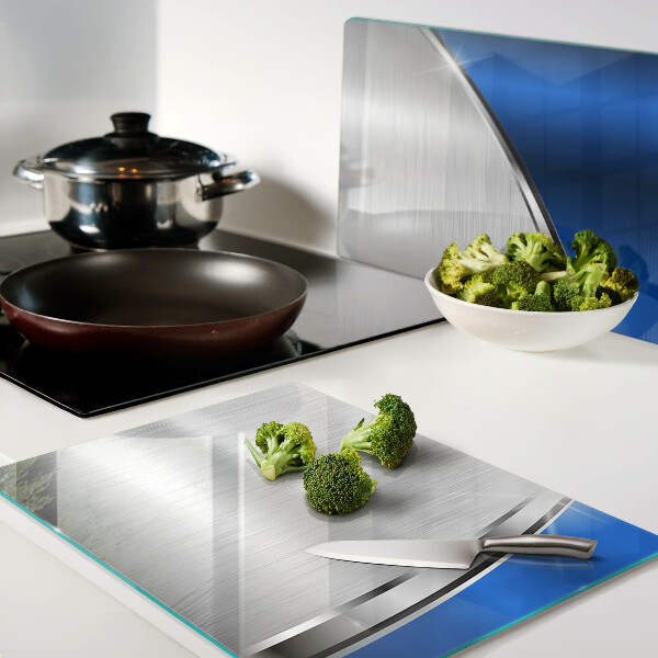 Szklana deska kuchenna z metalicznym wzorem i niebieskimi akcentami