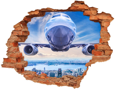 Foto zdjęcie dziura na ścianę Samolot nad miastem